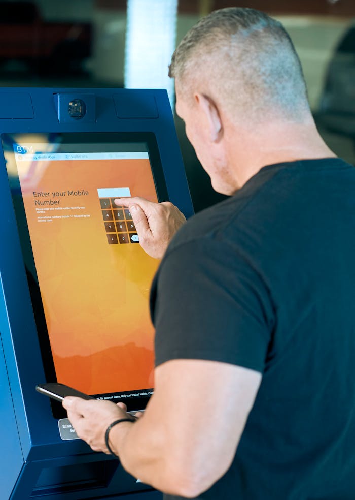 Man in Black Crew Neck Shirt using ATM